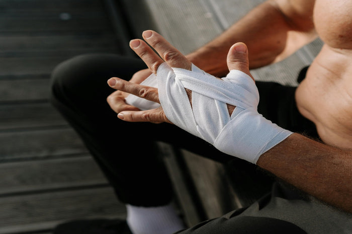 Man wrapping his hands before a boxing match